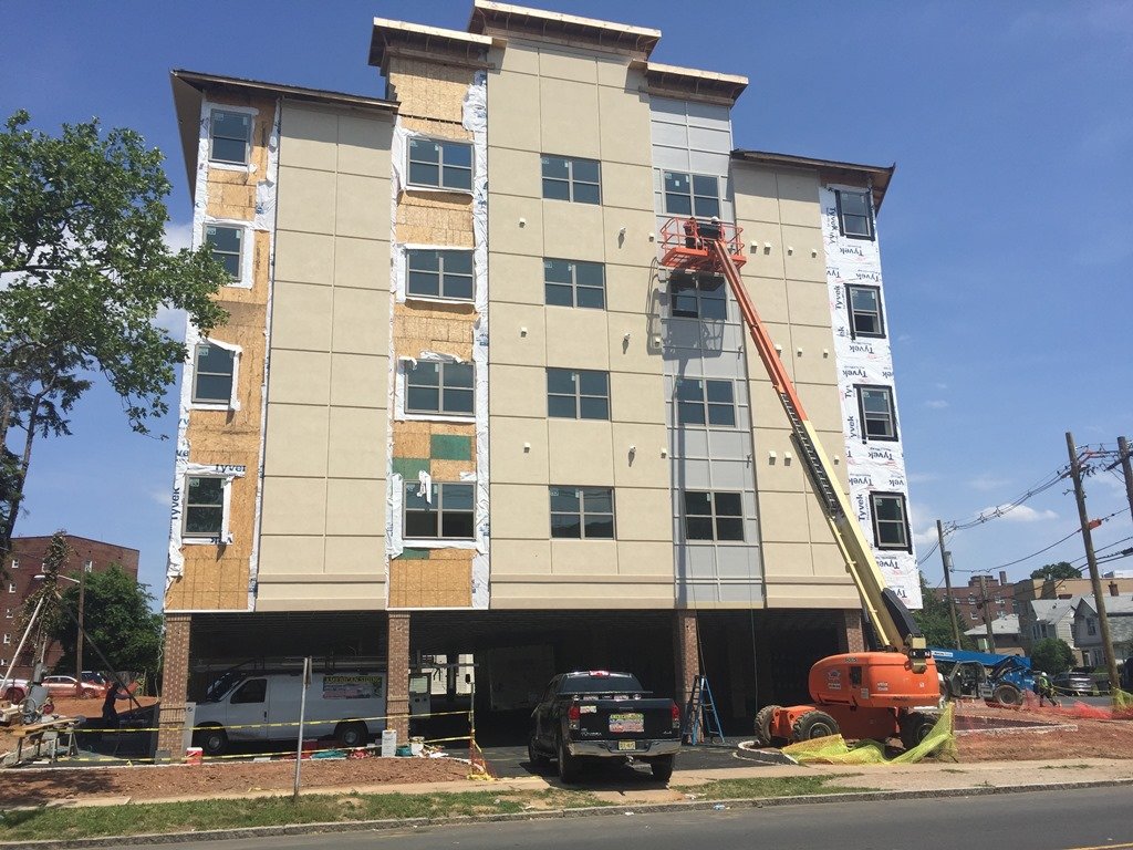 Multistory building exterior with facade work in progress