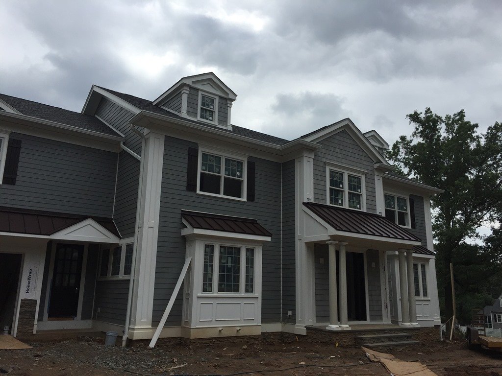 Gray siding, white trim and windows on a company exterior project